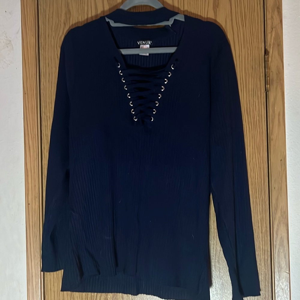 Navy blue ribbed sweater with tie up on chest and sweater goes around the neck